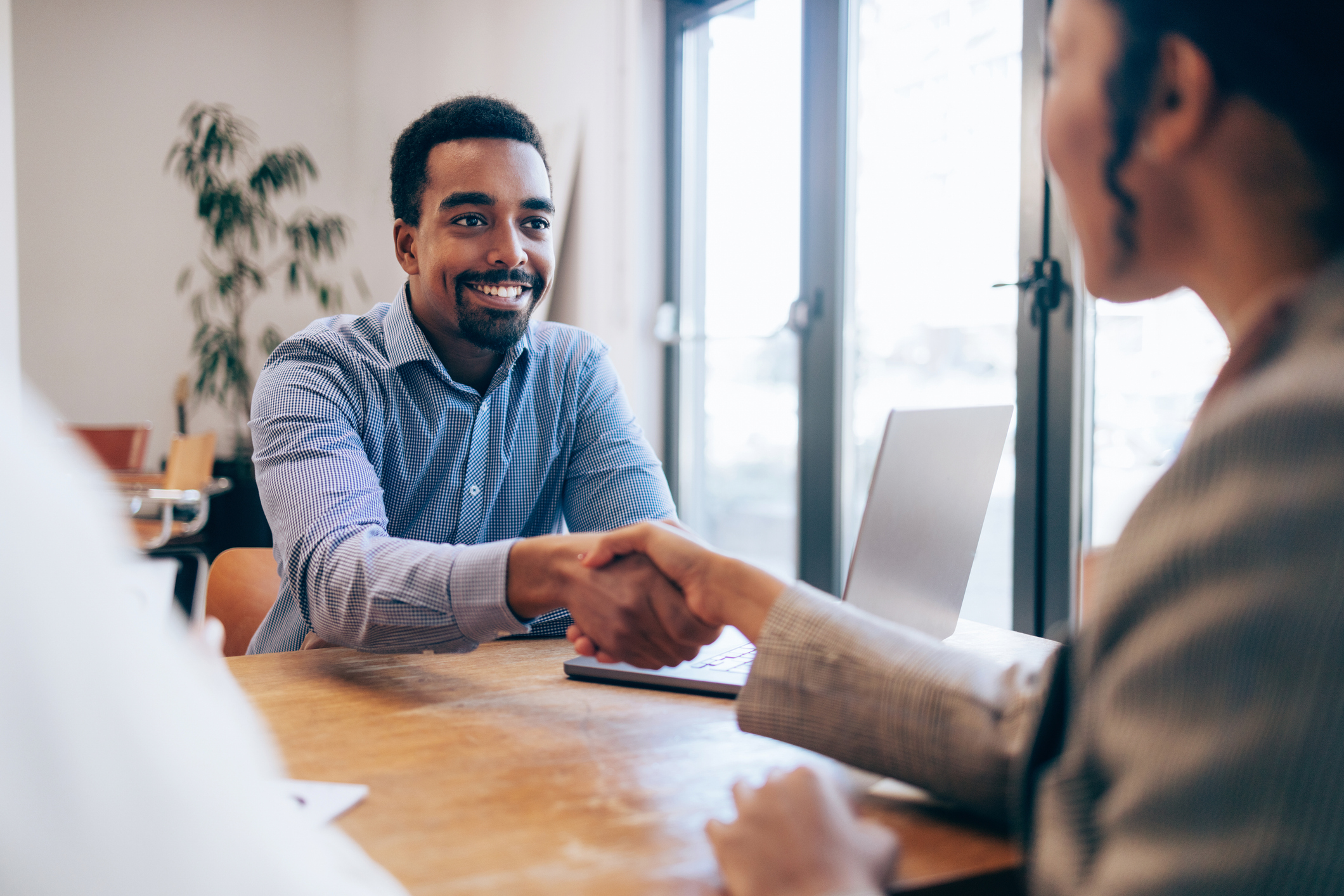 Man shakes hand after successful job interview.