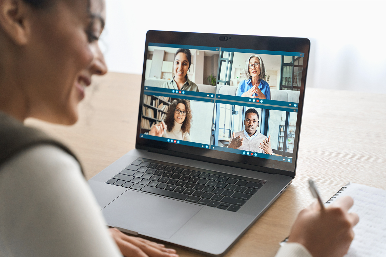 Woman in a virtual meeting on a laptop while working.