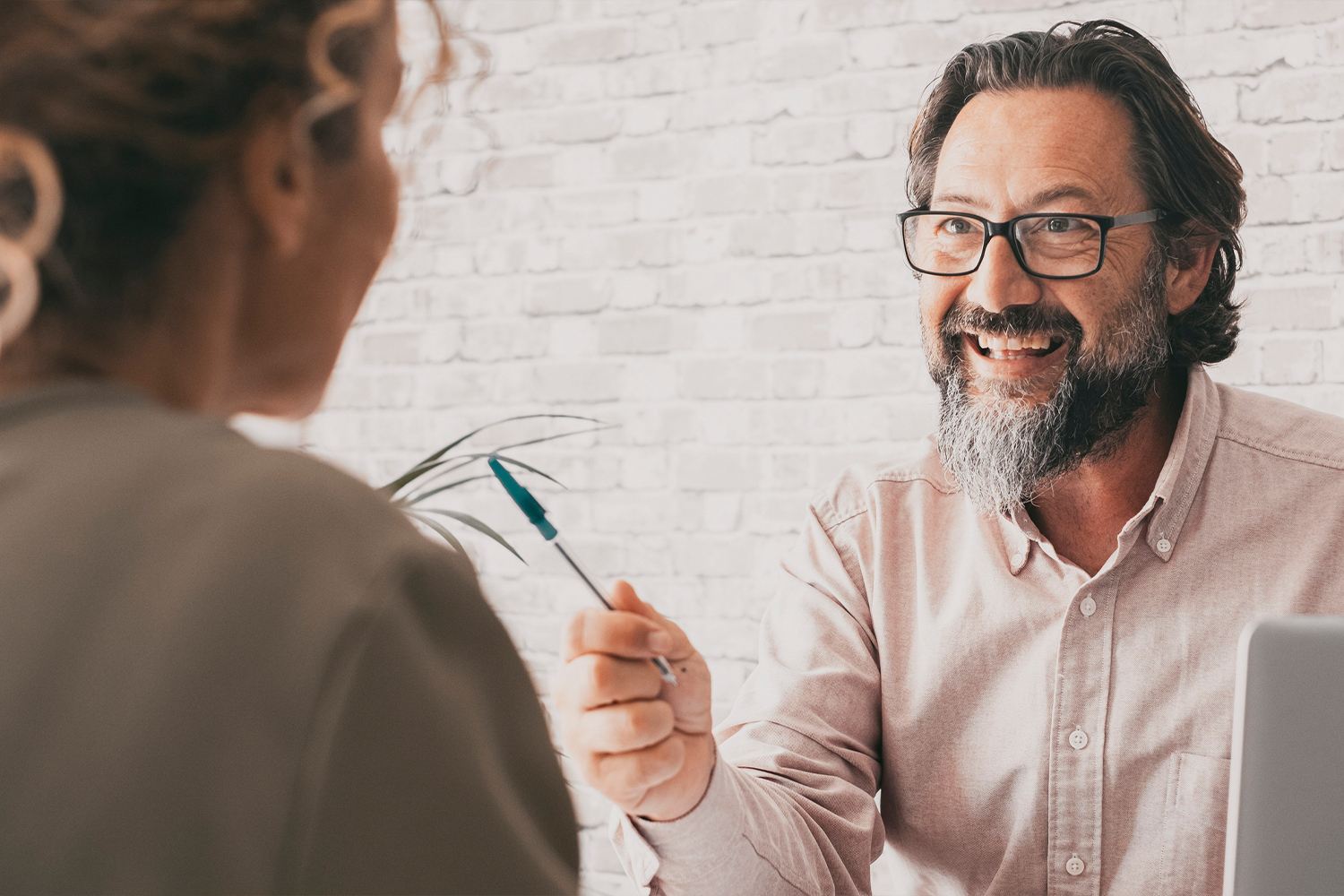 Man interviewing woman in office.