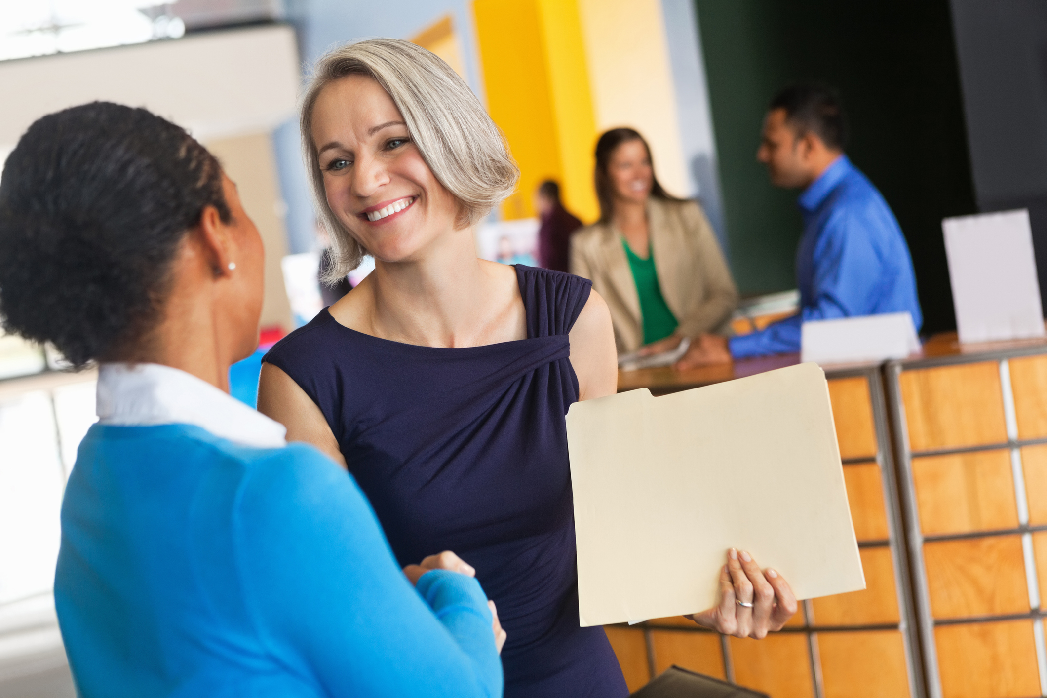 Woman shaking hands with prospective employer at a job fair.