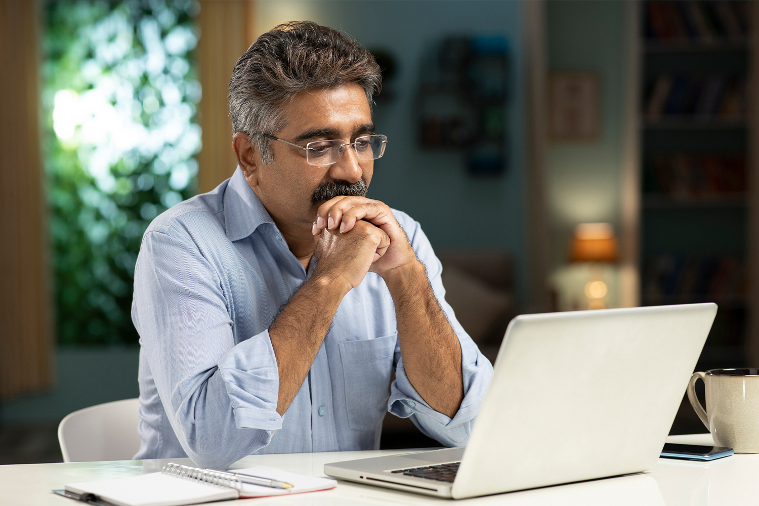 Man reading on a laptop.