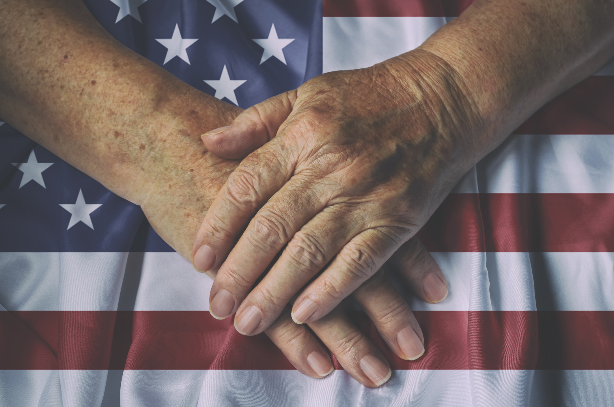 US Flag with hands together over it